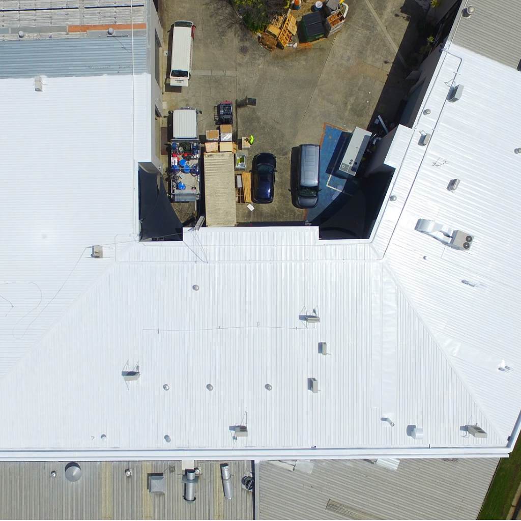 rusty-leaking-roof-waterproof-thermal-top-coat-applied-to-commercial-roof-1